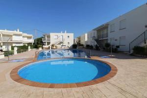 a large swimming pool in the middle of a courtyard at Cozy Apartment in Vinaròs with Shared Pool in Vinarós