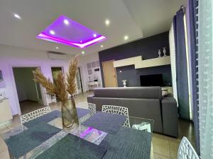 a living room with a table and a purple ceiling at Wedgewood - The XL Suite in Sliema +4 photos
