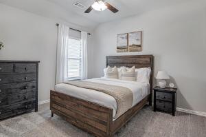 a bedroom with a large bed and a ceiling fan at Where Comfort Meets Convenience in Burleson