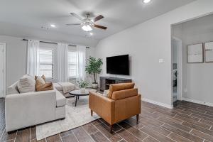 a living room with a couch and a tv at Where Comfort Meets Convenience in Burleson
