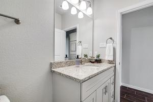 a bathroom with a sink and a large mirror at Where Comfort Meets Convenience in Burleson +19 photos