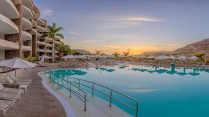 a large swimming pool with chairs and umbrellas at a resort at Anfi del Mar Tauro Golf 1 Emerald Club in Mogán +120 photos