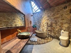 a stone bathroom with a tub and a toilet at Tam Coc Thoms House in Ninh Binh +149 photos