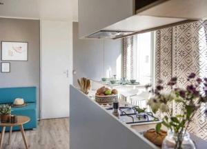 a kitchen with a counter top with a stove top oven at Camping 4 etoiles - Espace aquatique - 500m plage - ccagefg in Portiragnes