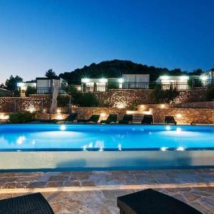 a large swimming pool at night with lights at Camp Panorama with pool in Drage