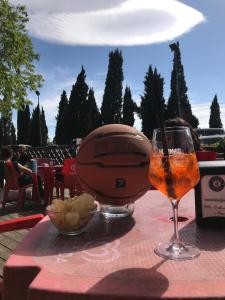 a table with a drink and a baseball helmet on it at A Modo Mio - Monolocale - Zona Stadio Ospedale Maggiore in Bologna +27 photos
