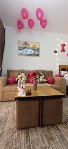 a living room with pink balloons hanging from the ceiling at Luxury Studio Pool & Free Private Beach, Close to Airport in Hurghada +68 photos