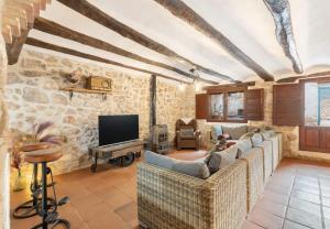 a living room with couches and a tv at La Casuna de la Una in Olba