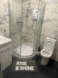 a bathroom with a shower and a sign that says rise and shine at The millstone residents in Bradford