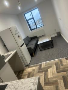 a living room with a couch and a table at The millstone residents in Bradford
