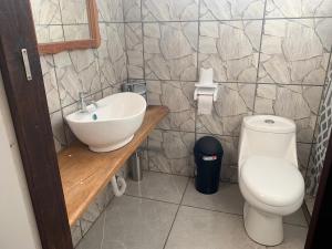 a bathroom with a sink and a toilet at Casa Mia in Sámara