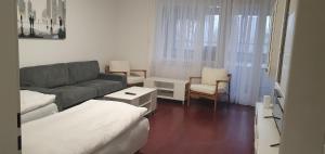 a small living room with a couch and chairs at Ferienwohnung-Montagewohnung 4 in Paderborn +5 photos