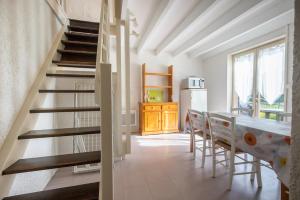 a kitchen with a staircase and a table and chairs at CAMPING LE SAILLET Lestelle Betharram in Lestelle-Bétharram +29 photos