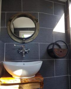 a bathroom with a sink and a mirror on a wall at Thuis op Flakkee in Ooltgensplaat +21 photos