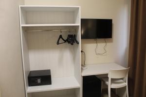 a white closet with a desk and a computer in it at Pisani Hotel in San Nicola La Strada
