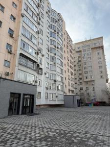 a large apartment building with two tall buildings at Ala-Too Central Square Residence in Bishkek