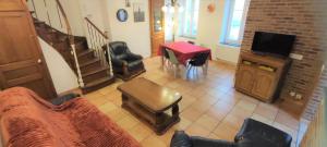 a living room with a couch and a table at Le haut clocher in Fumay