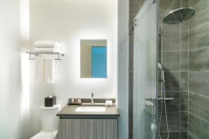 a bathroom with a sink and a shower at Ellipse Resort, Grace Bay in Providenciales +55 photos