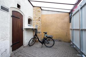 a bike parked next to a building with a door at ApartOne Hotel Brückenschänke in Sebnitz