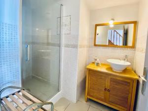 a bathroom with a glass shower and a sink at Location Luccini in Saintes-Maries-de-la-Mer +29 photos
