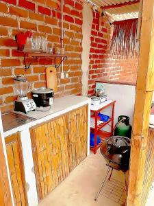 a kitchen with a brick wall and a counter top at Vista Palmeras in Zorritos +15 photos