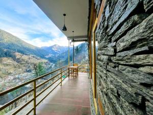 a balcony with a view of a mountain at Jibhi Emberwood in Jibhi