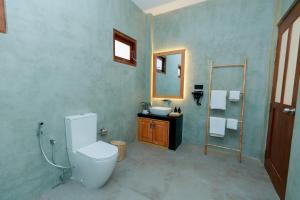 a bathroom with a toilet and a sink at KIRI's HEAVEN in Ahangama