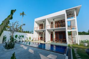 a house with a swimming pool in front of it at KIRI's HEAVEN in Ahangama