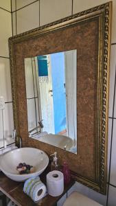 a mirror in a bathroom with a sink and a tub at La Petite France in Nova Petrópolis +137 photos
