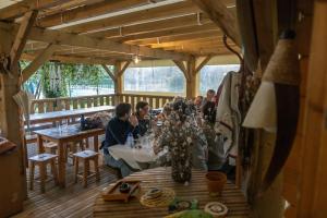 a group of people sitting at tables in a restaurant at CAMPING LE SAILLET Lestelle Betharram in Lestelle-Bétharram