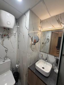 a bathroom with a sink and a mirror at The Sterling Aroma in Greater Noida
