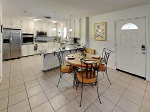 a kitchen with a table and chairs in a kitchen at Paradise Retreat in Port Aransas