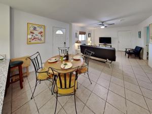 a dining room and living room with a table and chairs at Paradise Retreat in Port Aransas +23 photos