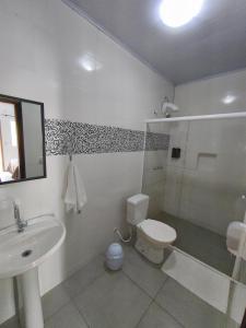 a bathroom with a sink and a toilet and a shower at Pousada Villa do Mar in Penha +17 photos