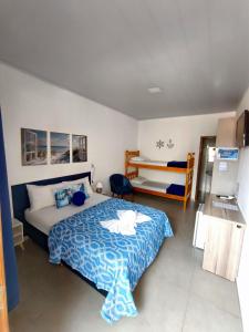 a bedroom with a bed and a bunk bed at Pousada Villa do Mar in Penha