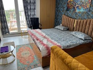 a bedroom with a bed and a couch in it at Zirakpur 3 Peoples Sleeping in Zirakpur