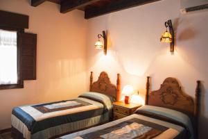 two beds in a room with two lamps at Casa Huerta San Francisco in Casarabonela +31 photos
