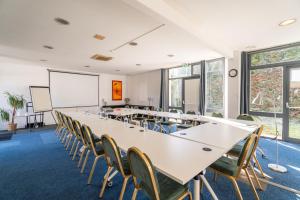 a conference room with a long table and chairs at Escale Kennedy in Mérignac