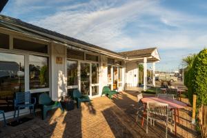 a building with chairs and tables on a patio at Escale Kennedy in Mérignac
