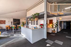 a restaurant with a counter in the middle of a building at Escale Kennedy in Mérignac
