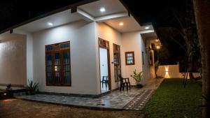 a house with a door and a porch at night at Golden Breeze Mirissa in Kamburugamuwa