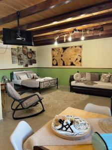 a room with two beds and a table and chairs at Sofilia view house in Argilia