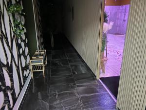 a hallway with a door open to a room with a chair at Étoile relax in Douai