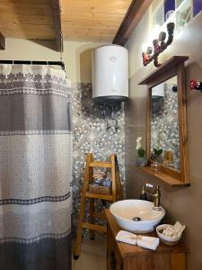 a bathroom with a sink and a shower curtain at Sofilia view house in Argilia +54 photos