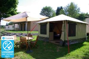 a tent with chairs and a table in front of a house at ZEcamping 3 étoiles dog friendly piscine chauffée en bordure de l'Allier in Lespéron