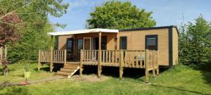 a tiny house with a porch and a deck at ZEcamping 3 étoiles animaux acceptés sauna piscine couverte in Mont-près-Chambord