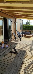 a wooden deck with a bench and a couch at ZEcamping 3 étoiles animaux acceptés sauna piscine couverte in Mont-près-Chambord