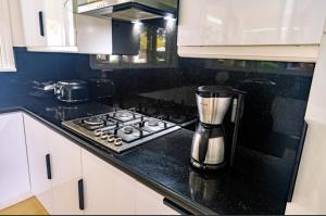 a kitchen with a coffeemaker sitting on a stove at Casa Negrense Private Resort in Dauin