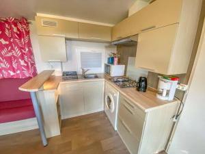 a small kitchen with a sink and a stove at Camping 3 étoiles - ccaidff in Beaulieu