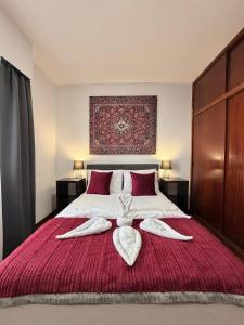 a bedroom with a bed with two towels on it at Ocean View Guest House in São Vicente +33 photos